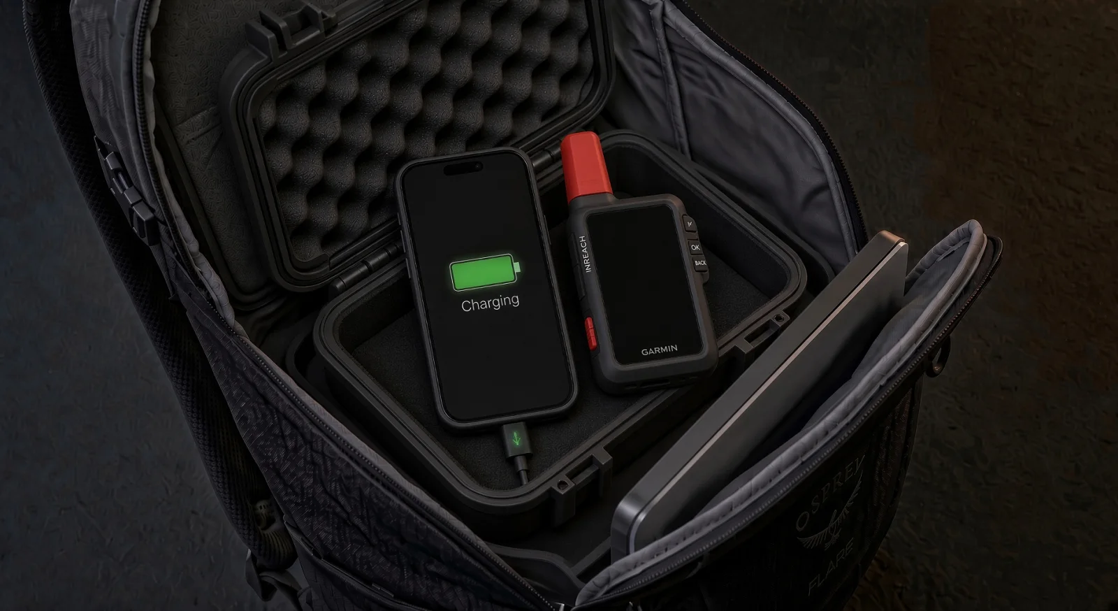 An Anywhere node open in its single-person pack: phone charging, satellite messenger beside it