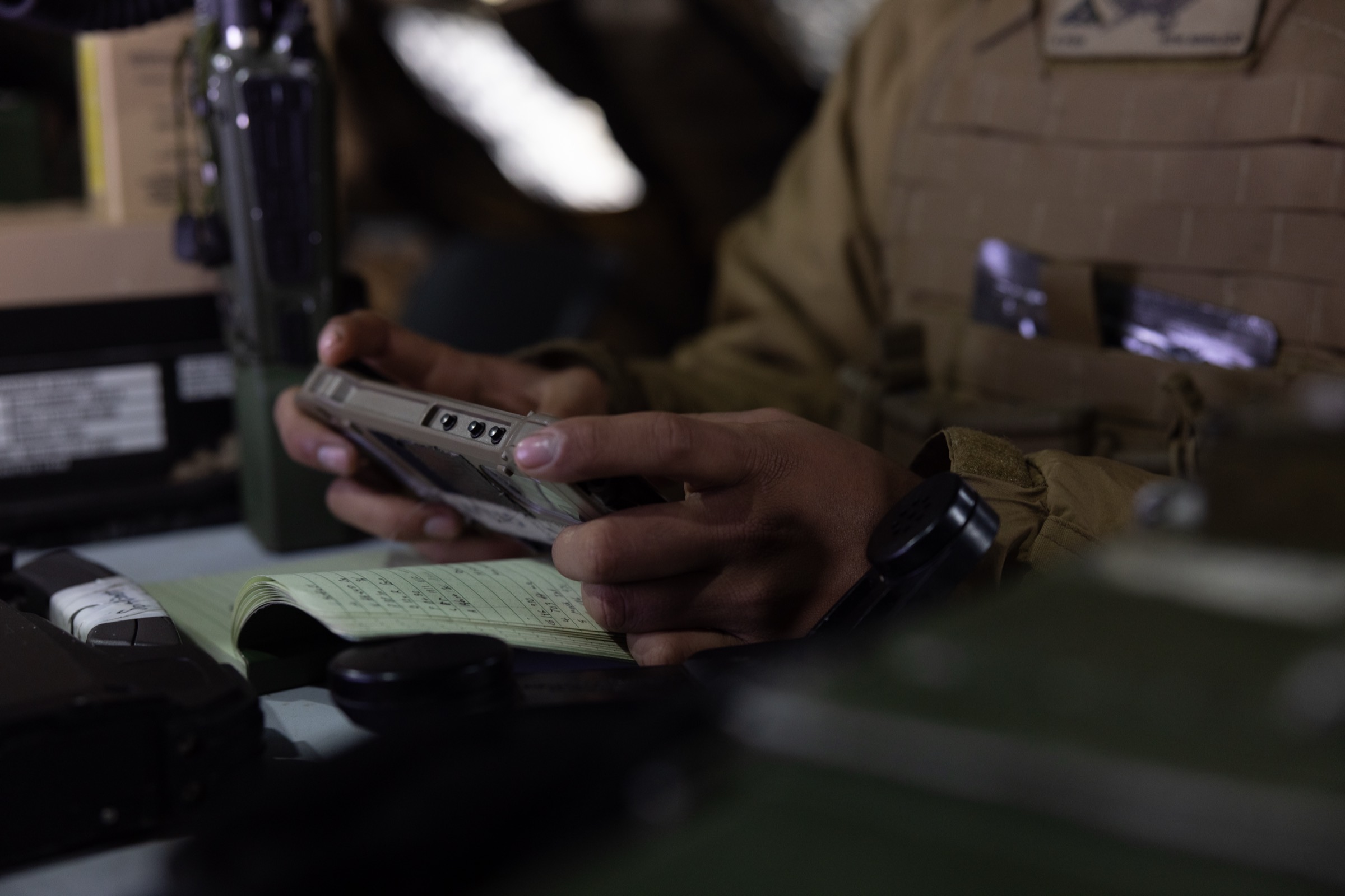 Operator holding a rugged smartphone running Mission Advantage